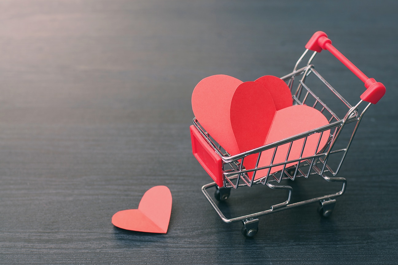 Full of hearts in the shopping cart on wooden floor