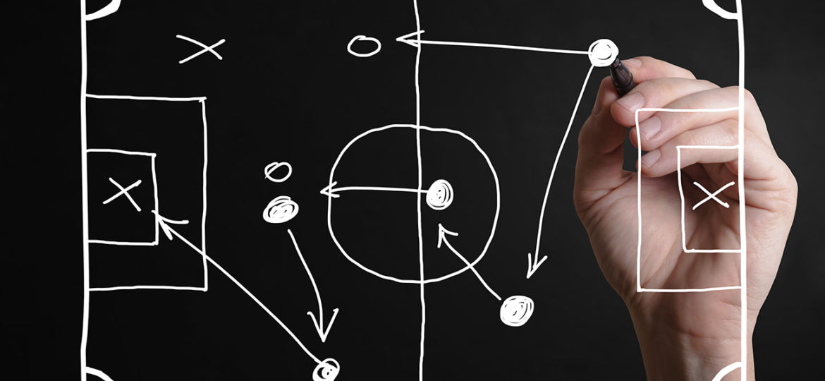 Hand drawing a football strategy plan drawn on a virtual screen
