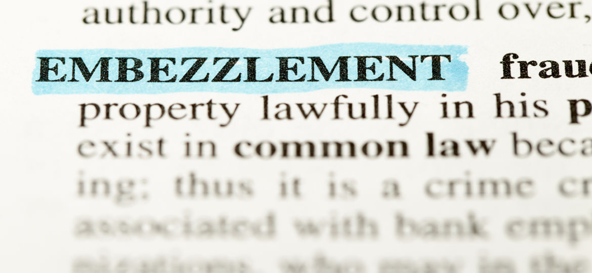 Definition of the words embezzlement from a law text book highlighted with a blue highlighter.